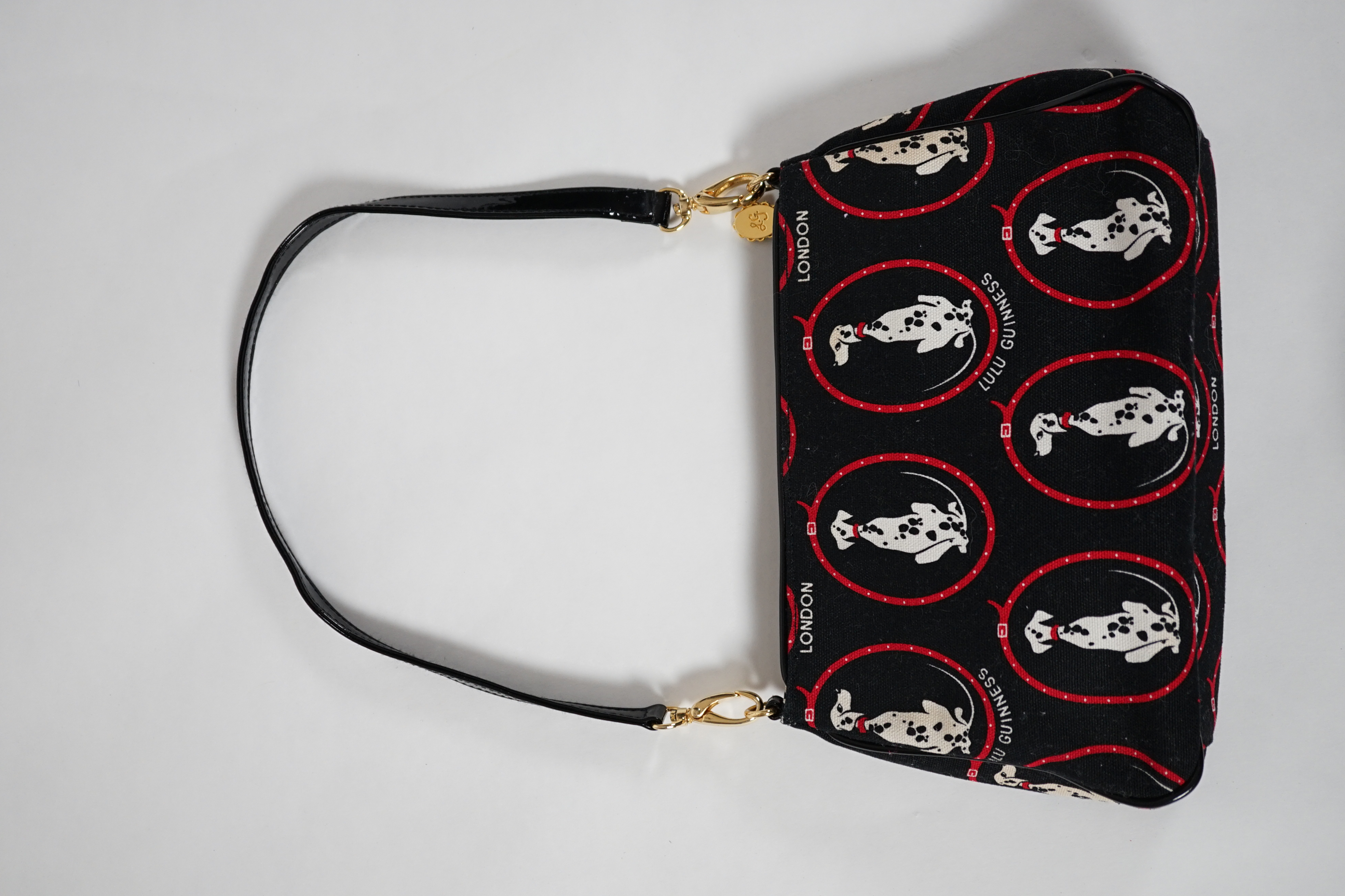 A vintage Lulu Guinness black canvas Dalmatian handbag with black patent leather strap and piping, height 15cm, height to strap 37cm, width 24cm, depth 5cm